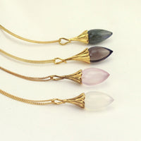 Charming acorn pendant, designed in gold, showcasing intricate details and a polished finish.