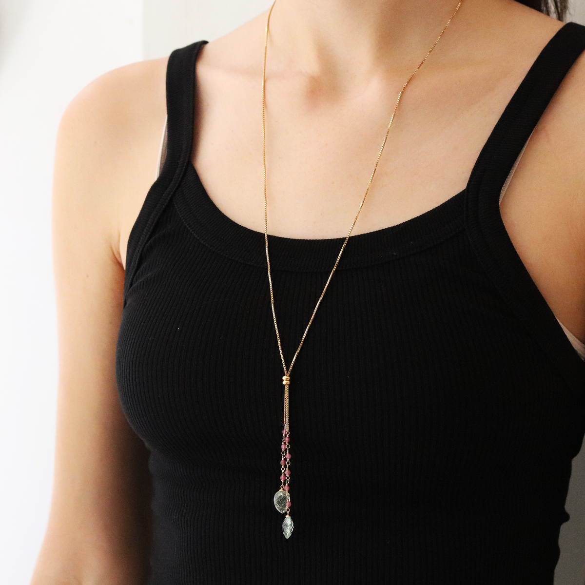 Model wearing a carved green amethyst and pink tourmaline lariat necklace for a sophisticated look.