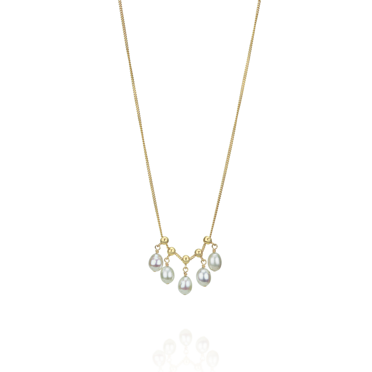 Delicate adjustable white pearl necklace, styled together with complementary pieces for a chic layered look.