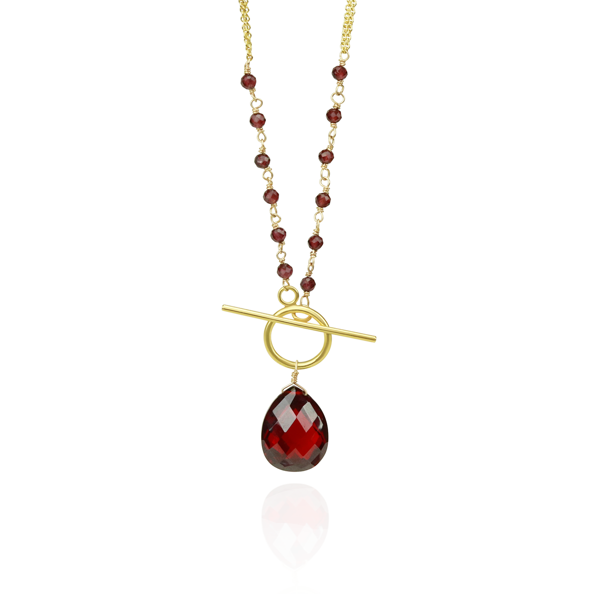 Elegant toggle pendant featuring a rich garnet gemstone with a pear-shaped garnet accent.