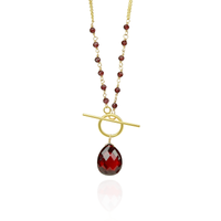 Elegant toggle pendant featuring a rich garnet gemstone with a pear-shaped garnet accent.