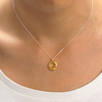Elegant gold halo pendant with a sparkling gemstone centerpiece, designed to add sophistication and style to your jewelry collection.