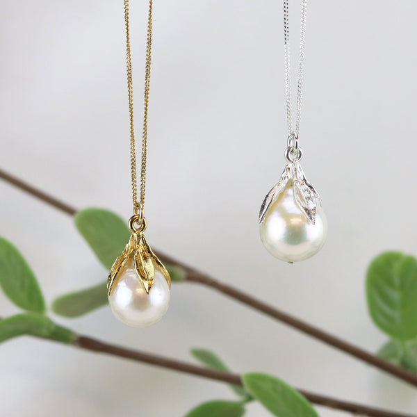 Elegant leaf and pearl pendants with a delicate, nature-inspired design.