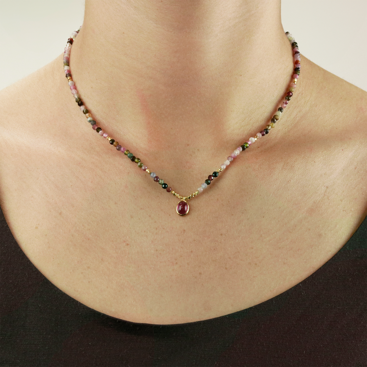 Elegant mixed tourmaline necklace displayed on a model, showcasing its vibrant faceted gemstones.