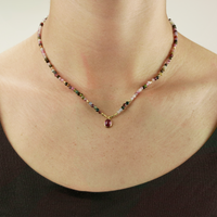 Elegant mixed tourmaline necklace displayed on a model, showcasing its vibrant faceted gemstones.