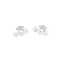 Elegant small triple pearl studs, perfect for adding a touch of sophistication to your outfit.