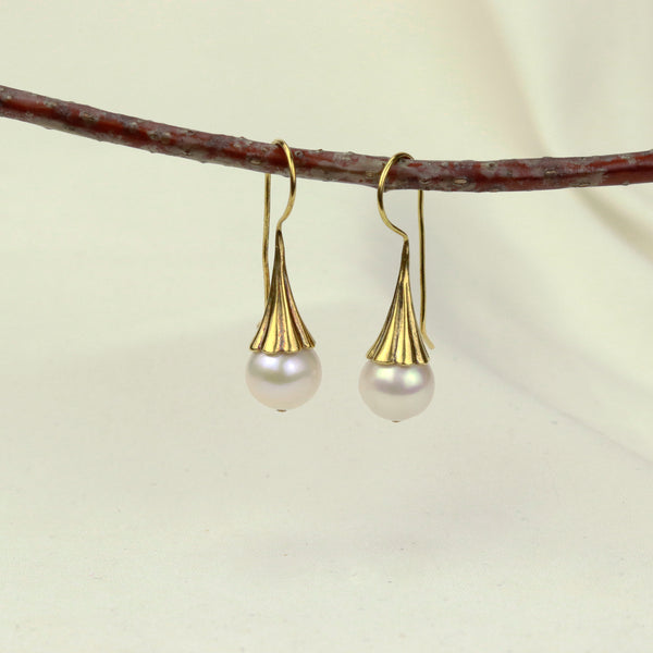 Elegant white pearl earrings, featuring a classic design that adds sophistication and timeless beauty to any outfit.