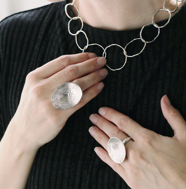 Model wearing a handcrafted sterling silver statement ring by MOUNIR Jewellery